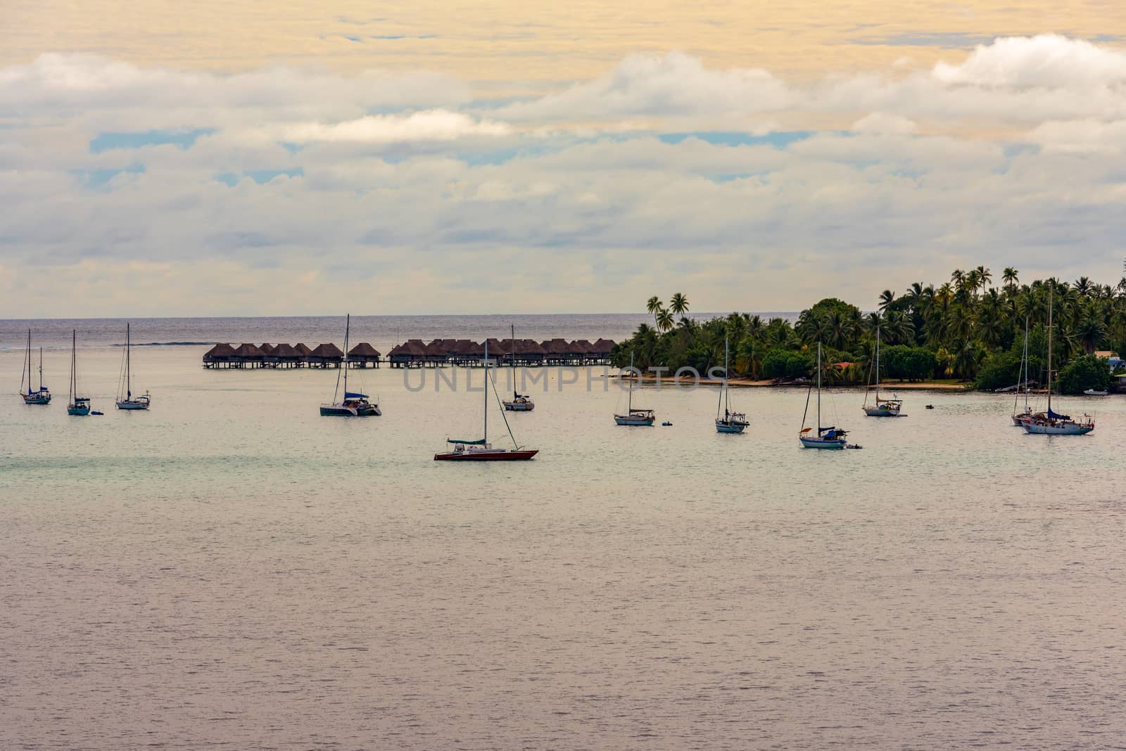 Boats are anchored off the island of Moorea, part of French Polynesia, early in the morning.