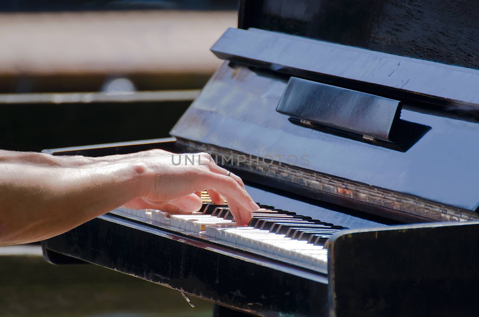 Musician plays the piano. The musician or composer touches the piano keys with his long fingers. Concept: sound, music, academy, concert, pianist