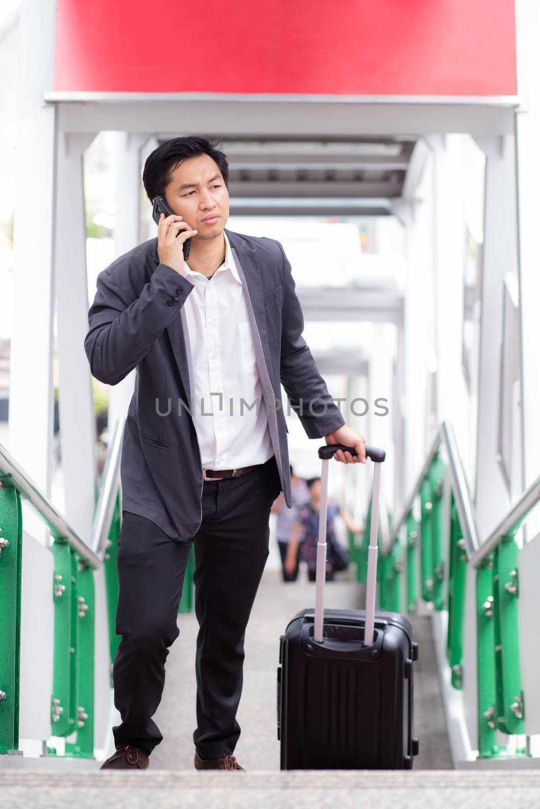 Businessman traveler journey business travel and talking phone. by nnudoo
