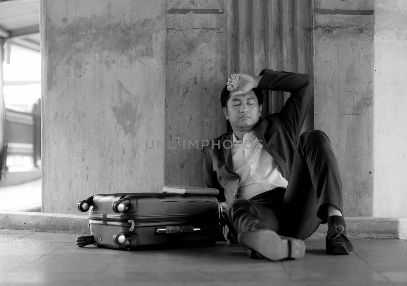 Stressed asian businessman bankrupt with sitting at outdoor.