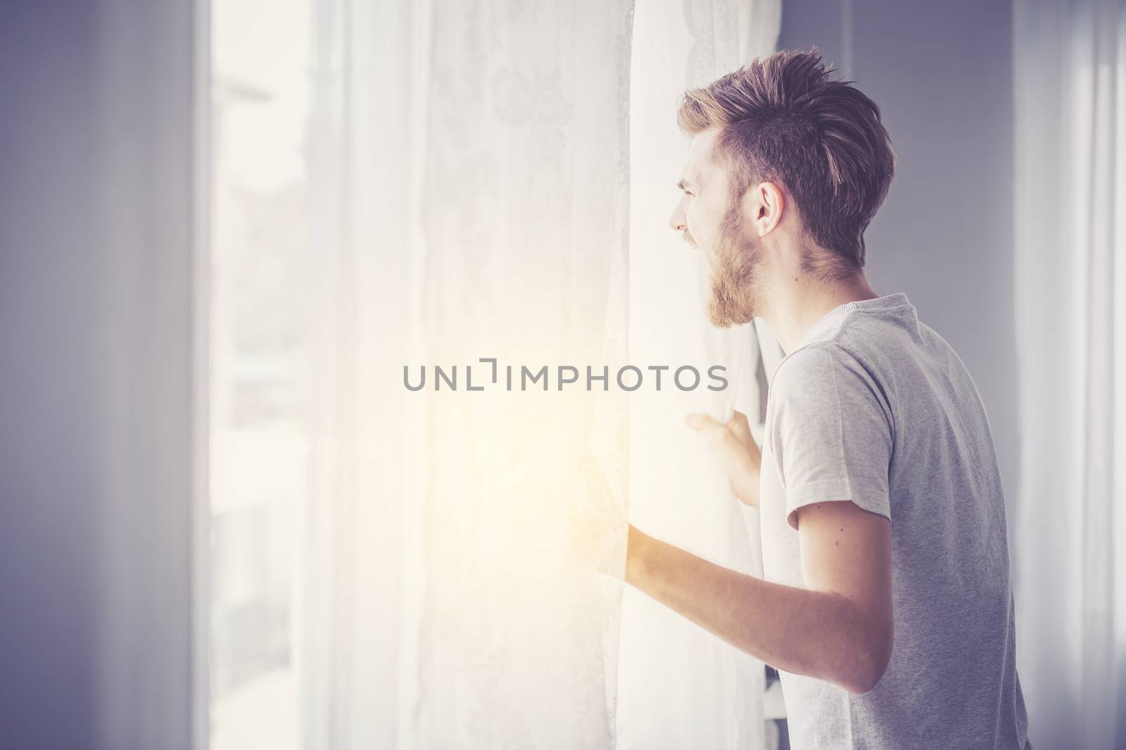 Screaming man with window in the bedroom.