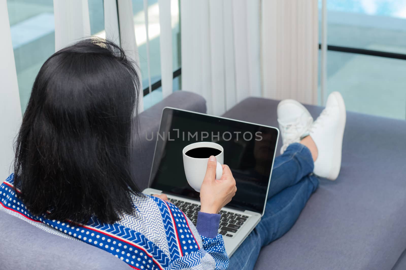 Closeup computer notebook on sofa with asian woman for work in lifestyle of woman concept.