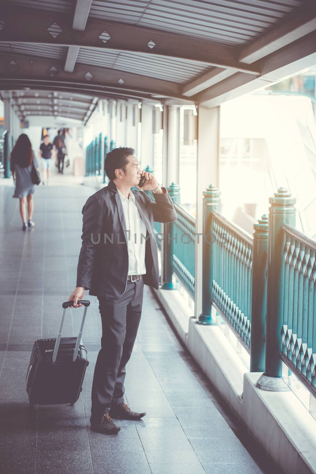 Businessman traveler journey and talking phone with business travel concept.