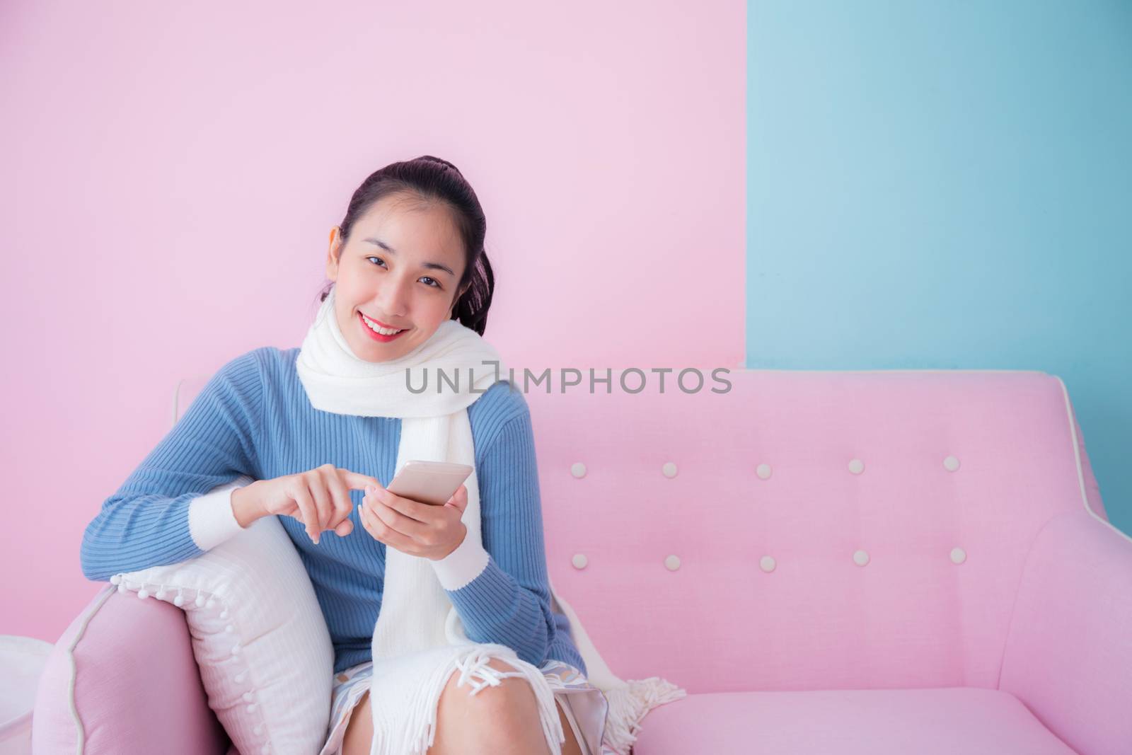 portrait of beautiful young woman relax on couch with smartphone communication concept.