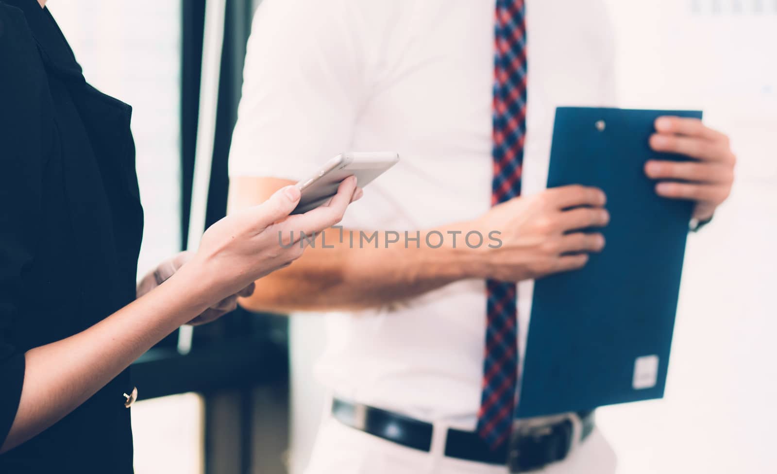 Business people meeting closeup of woman hand holdding smartphone with other businessman.