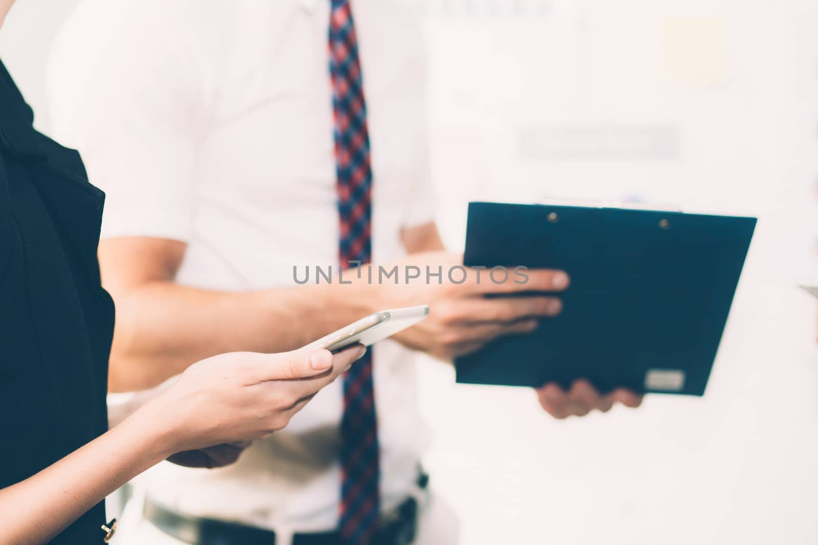 Business people meeting closeup of woman hand holdding smartphone with other businessman.