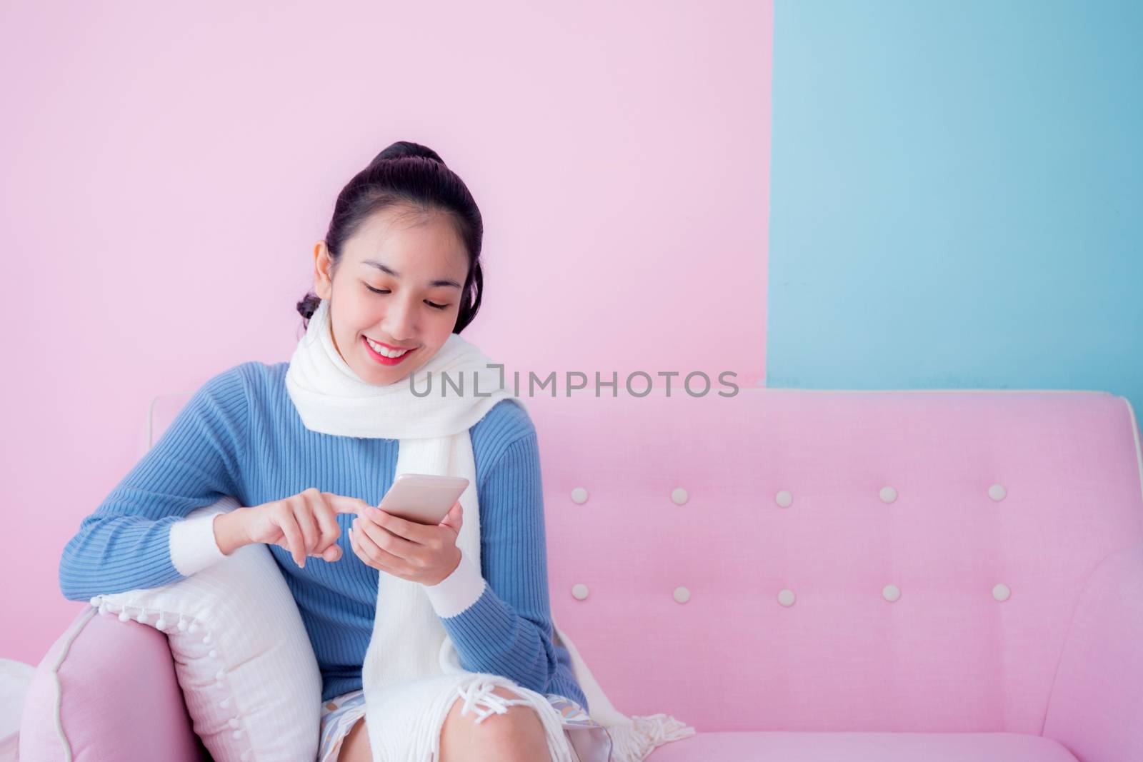portrait of beautiful young woman relax on couch with smartphone communication concept.