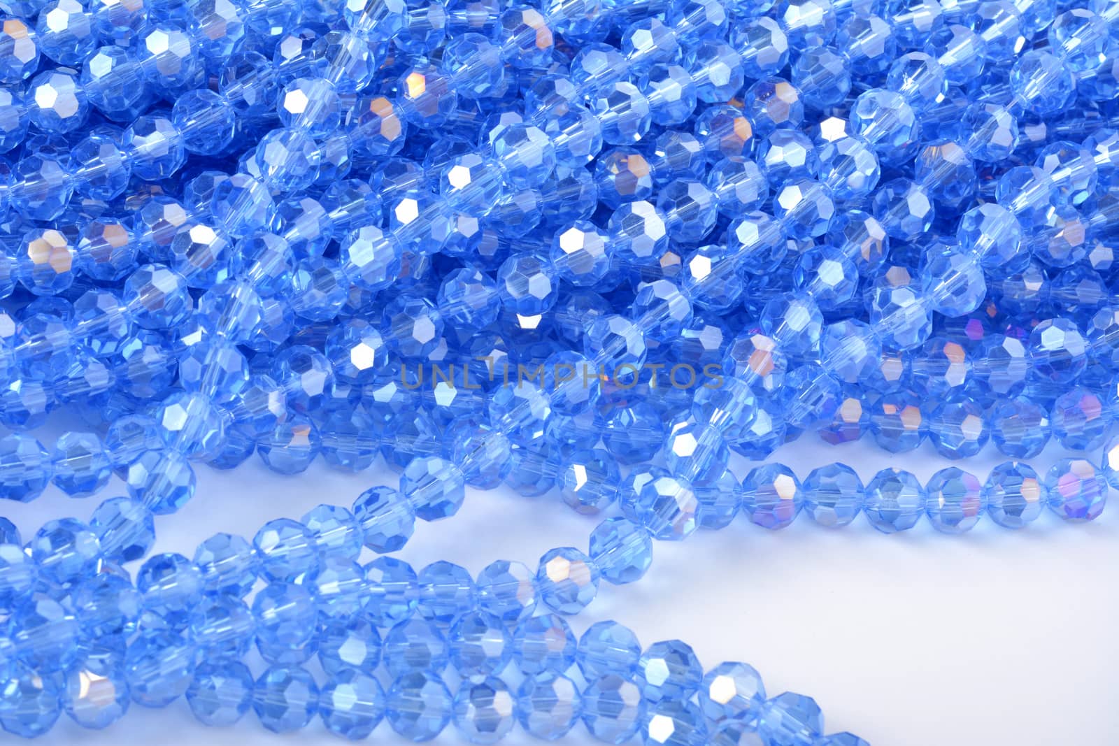 Beautiful Light Blue Glass Sparkle Crystal Isoalted Beads on white background. Use for diy beaded jewelry. Space for text
