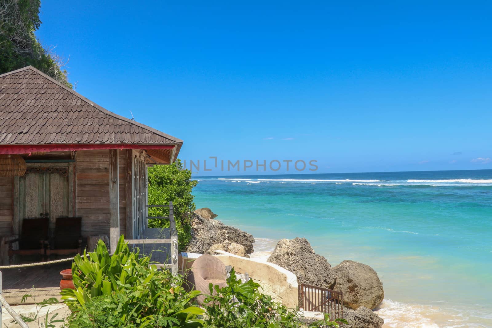 Tropical sea beach bungalow landscape. Beach bungalow on tropical beach scene. Tropical bungalow sand beach panorama.