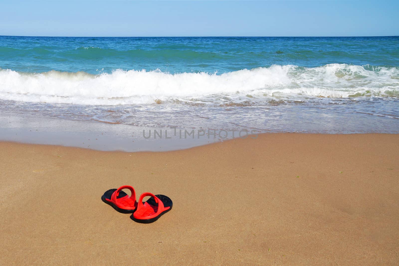 beach slates on sand against the background of the sea horizon, copy space. by Annado