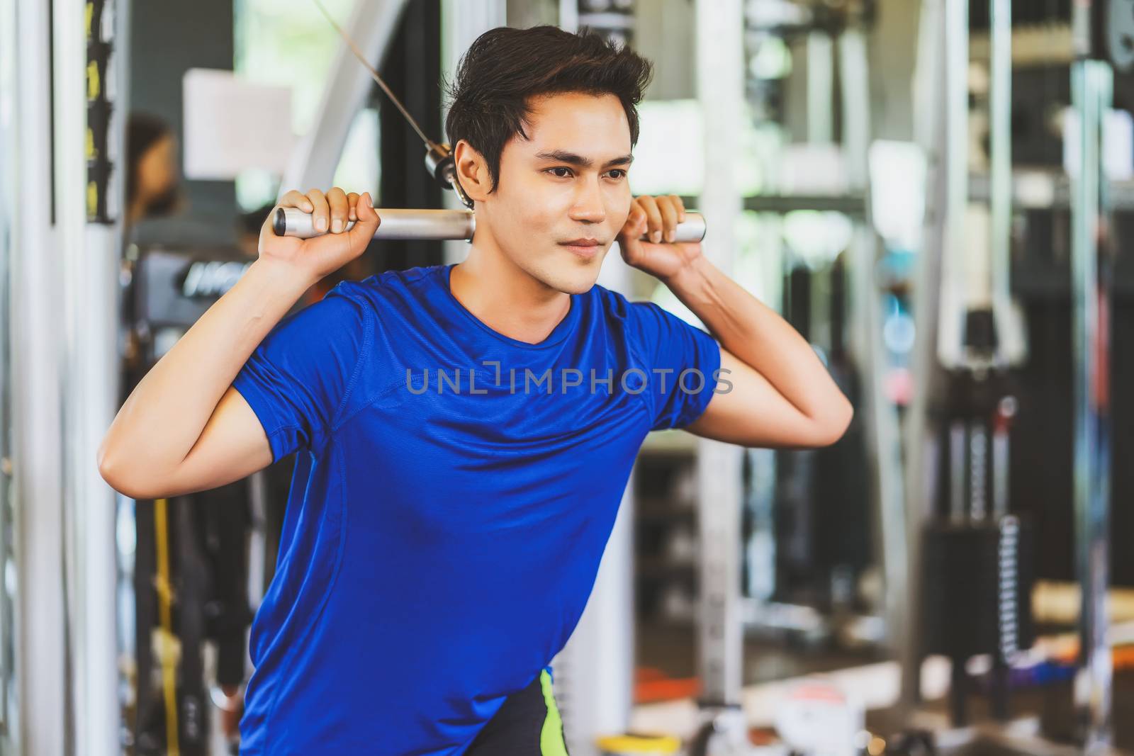 Young Asian man wearing sportswear doing excecise with the bar in gym fitness sport complex, posture position, sport club community, sports and healthcare concept,