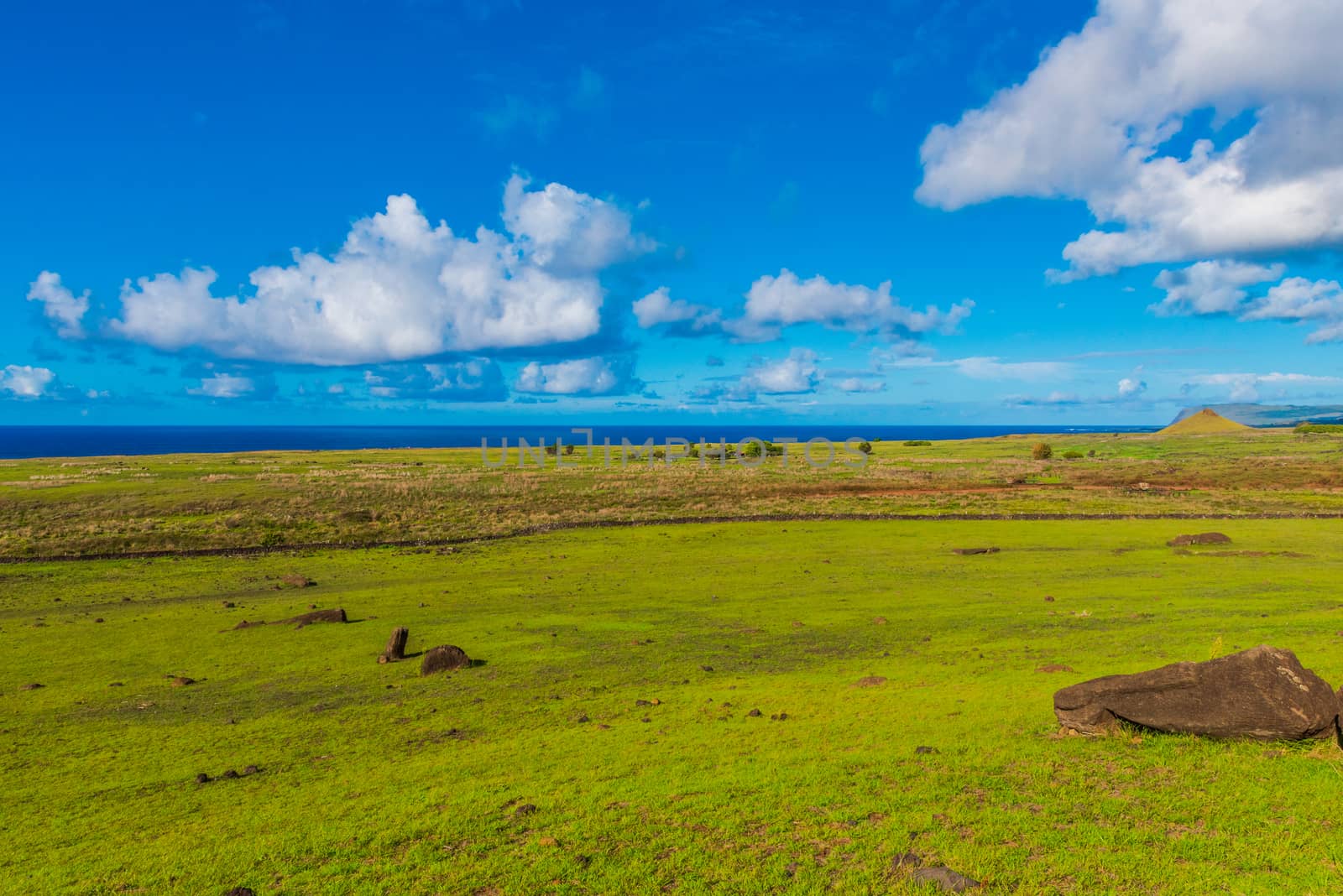 A sweeping view of the Easter Island  landscape leading to the Pacific Ocean.