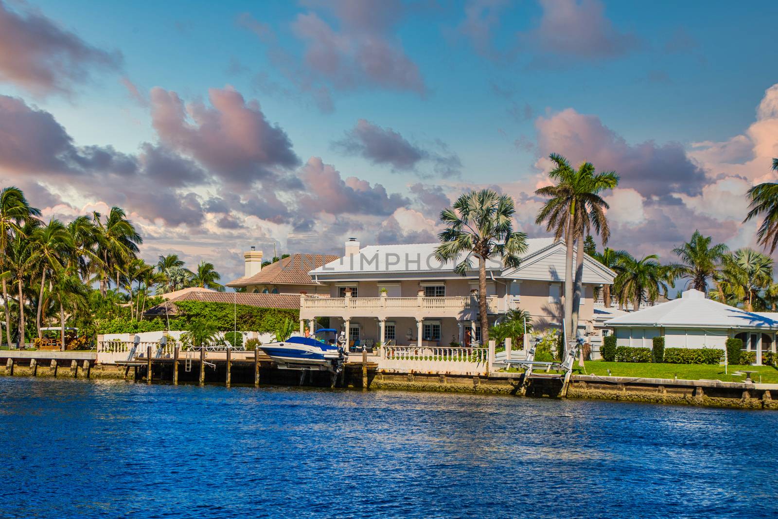 Boat on Dock by Intercoastal House by dbvirago