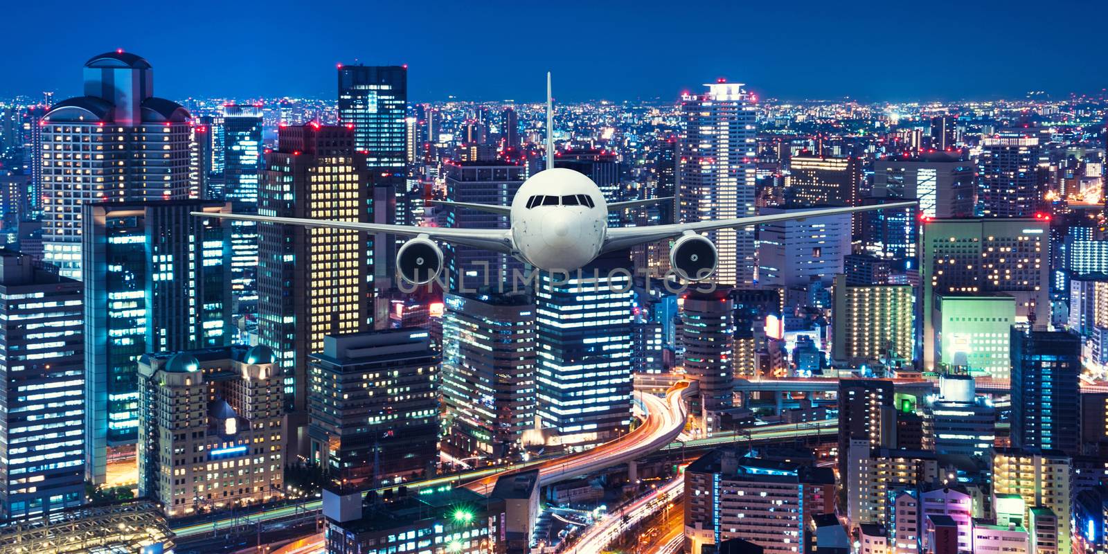 Airplane frying over the cityscape background by Surasak