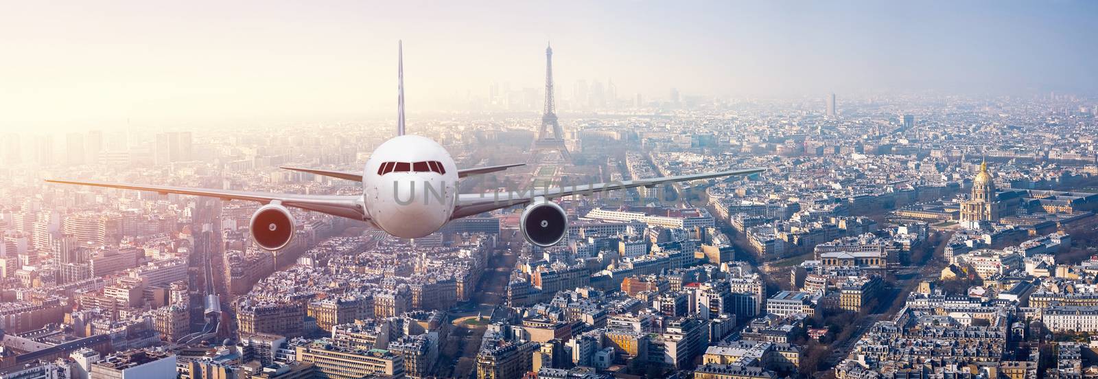 Airplane frying over the center of Paris, France by Surasak