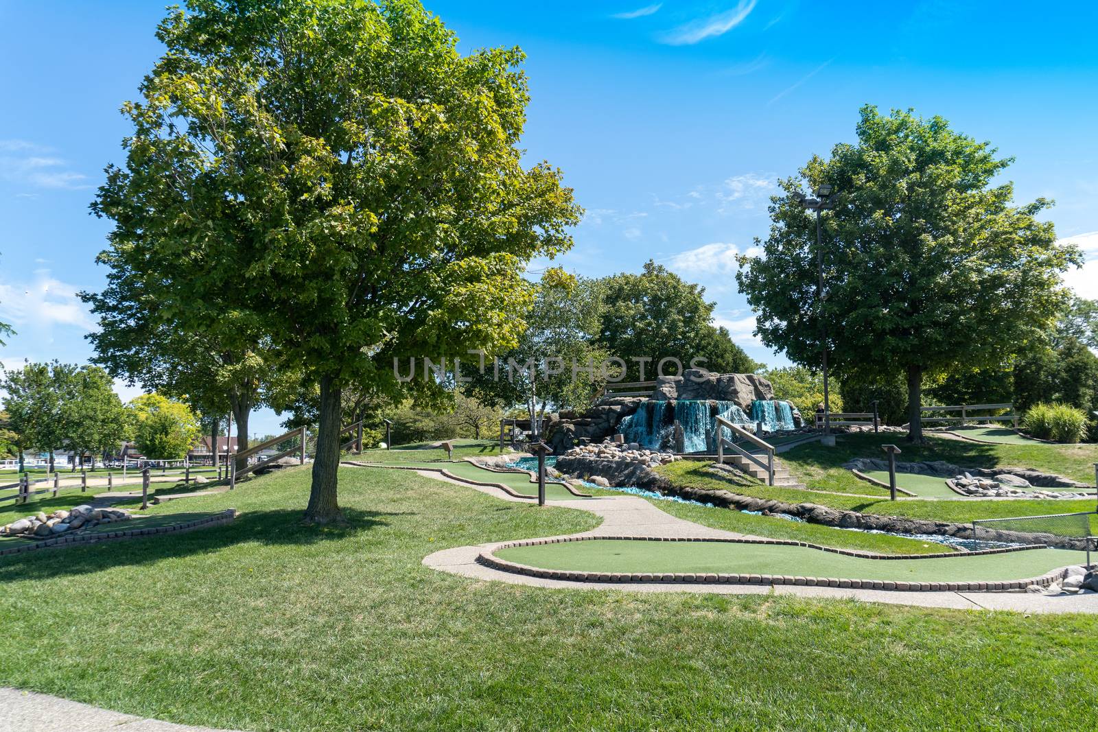 Miniature golf course with waterfall and hilly landscape