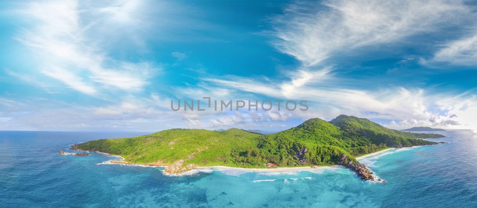 Tropical beach with sea and palm taken from drone. Seychelles famous beach - aerial photo of La Digue Grand Anse.