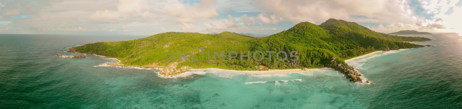 Aerial view of tropical island with sea, vegetation and shoreline.