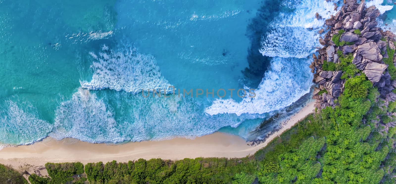 Amazing aerial view of Grand Anse in La Digue Island, Seychelles. Ocean and forest.