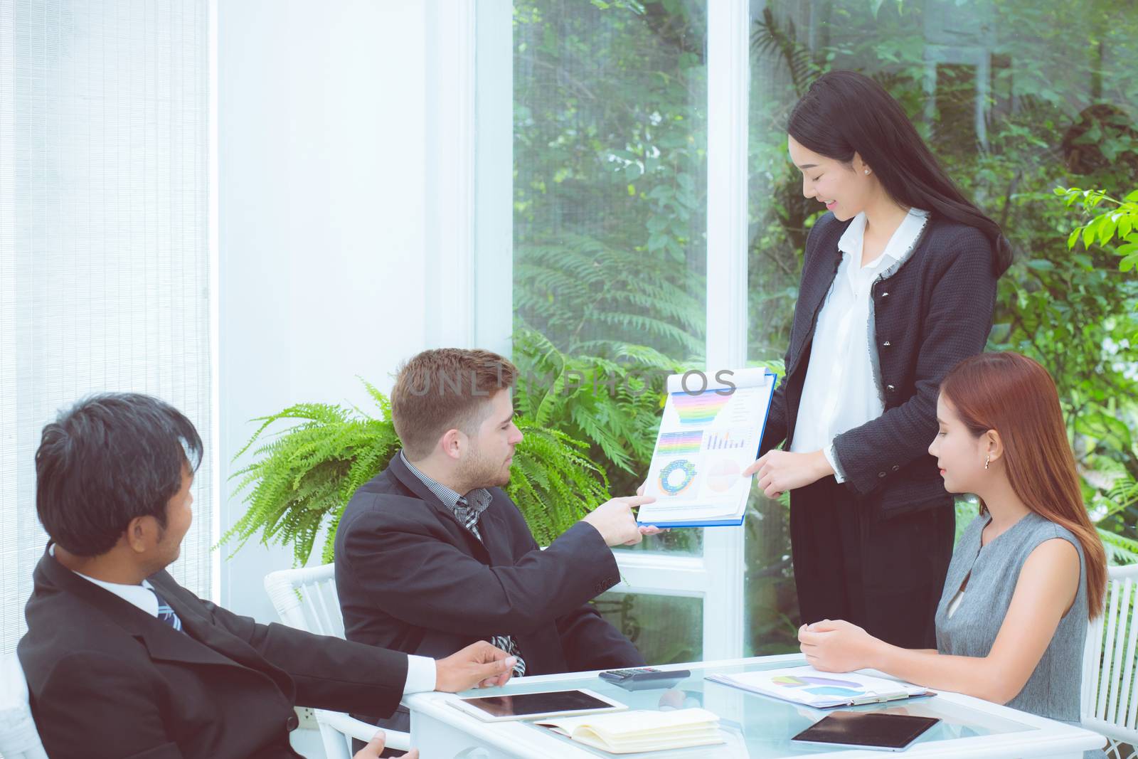 young business people making meeting and talking for analyzing marketing with graph working at office on desk.