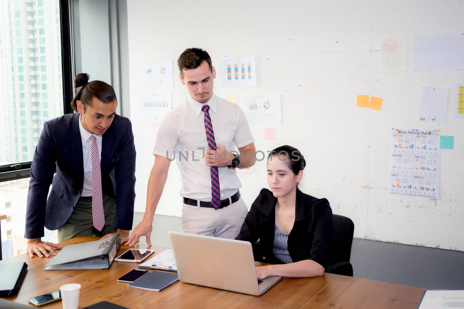 Business team having using laptop during a meeting and presents. by nnudoo