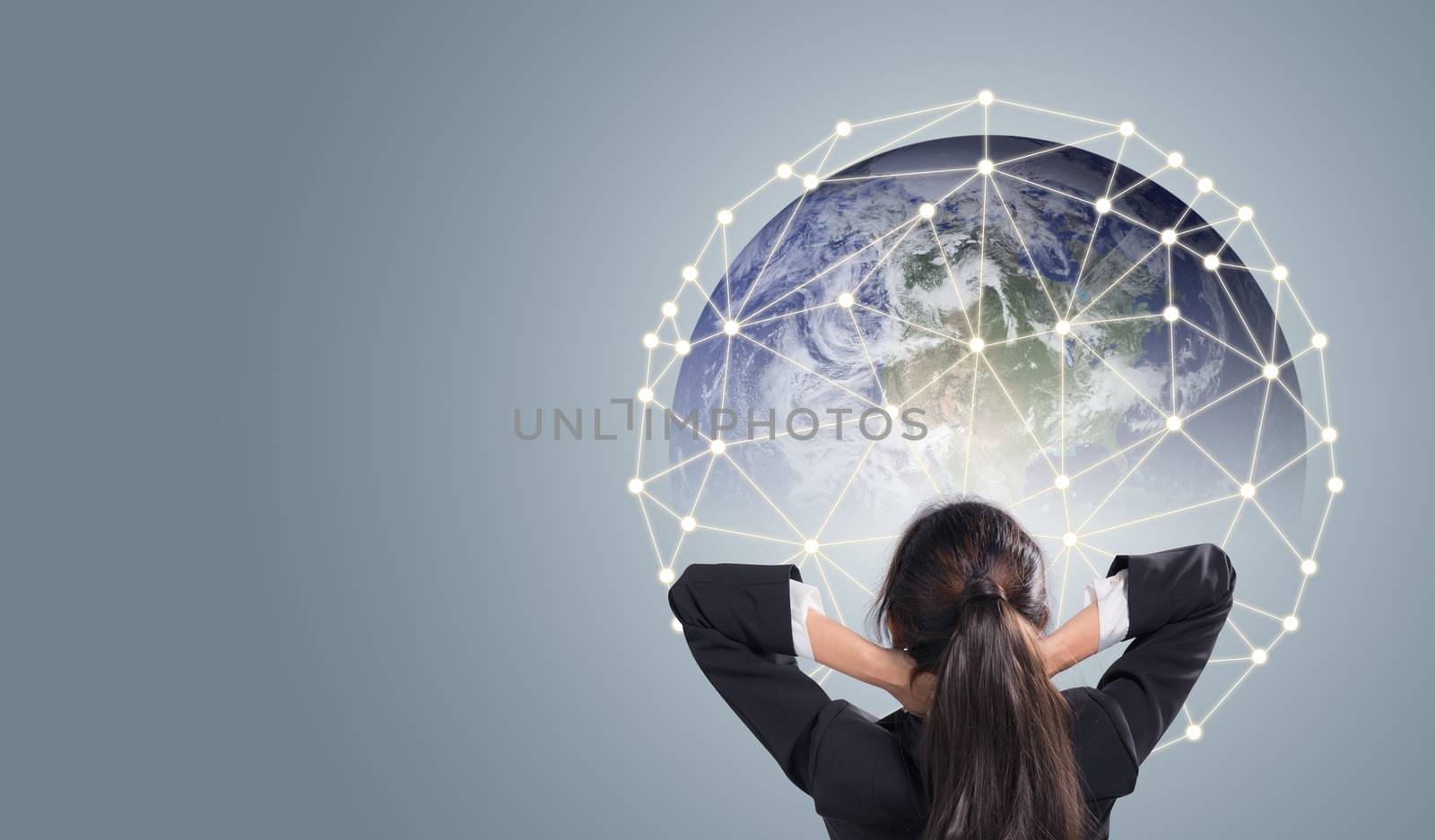 Rear view of businesswoman looking at network giant Earth communication network concept, Elements of this image furnished by NASA.