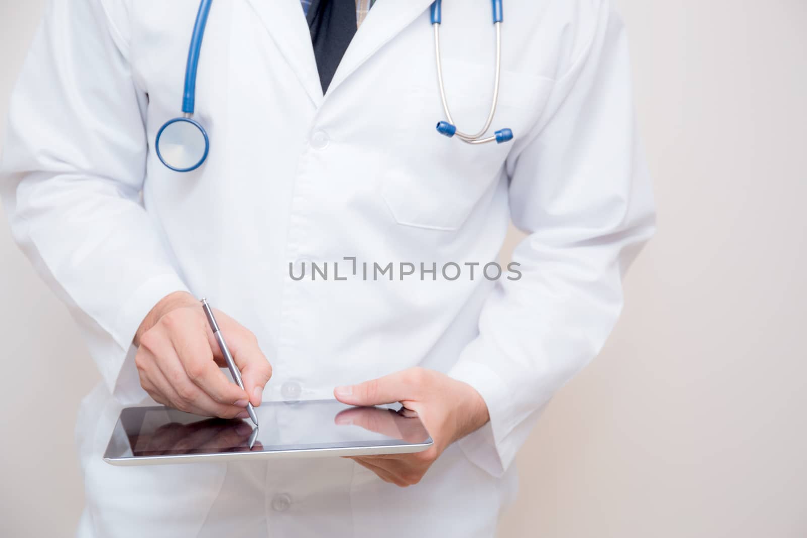 Doctor working on a digital tablet on white background. by nnudoo