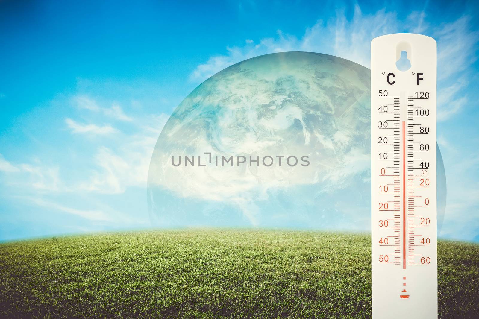 Thermometer check the earth's temperature with impact of global environment concept, Elements of this image furnished by NASA.