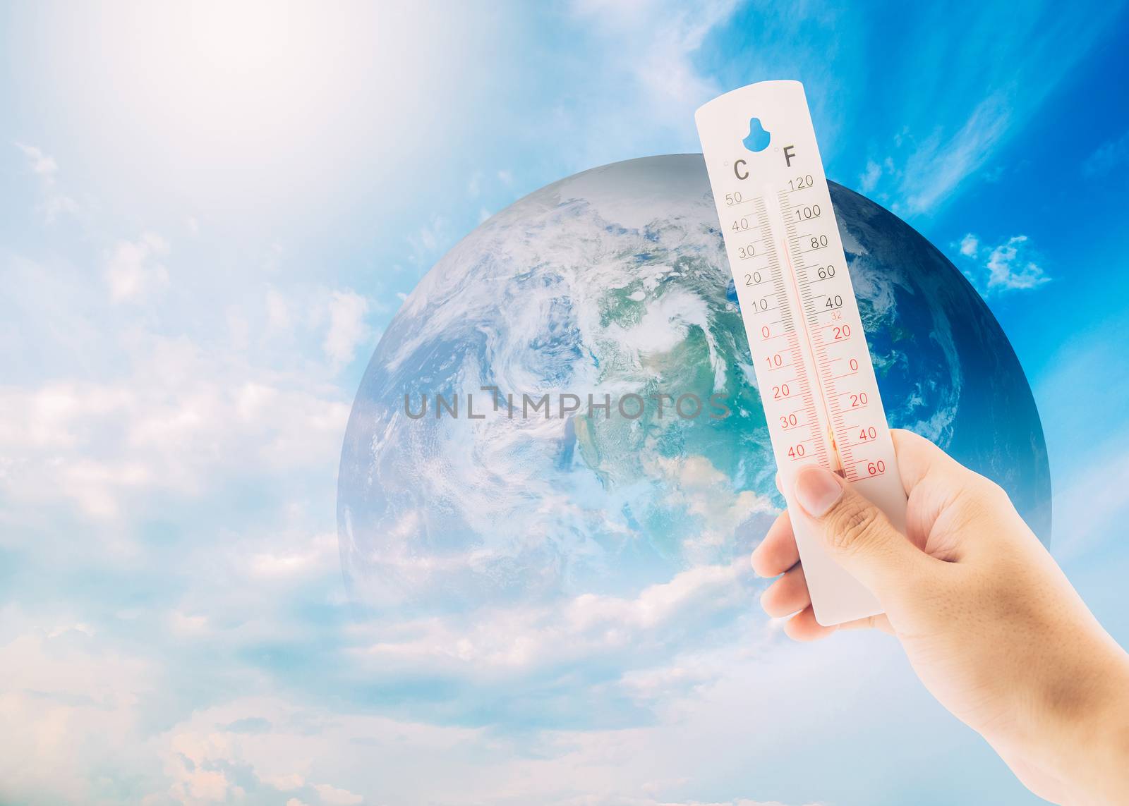 Thermometer check the earth's temperature with impact of global environment concept, Elements of this image furnished by NASA.