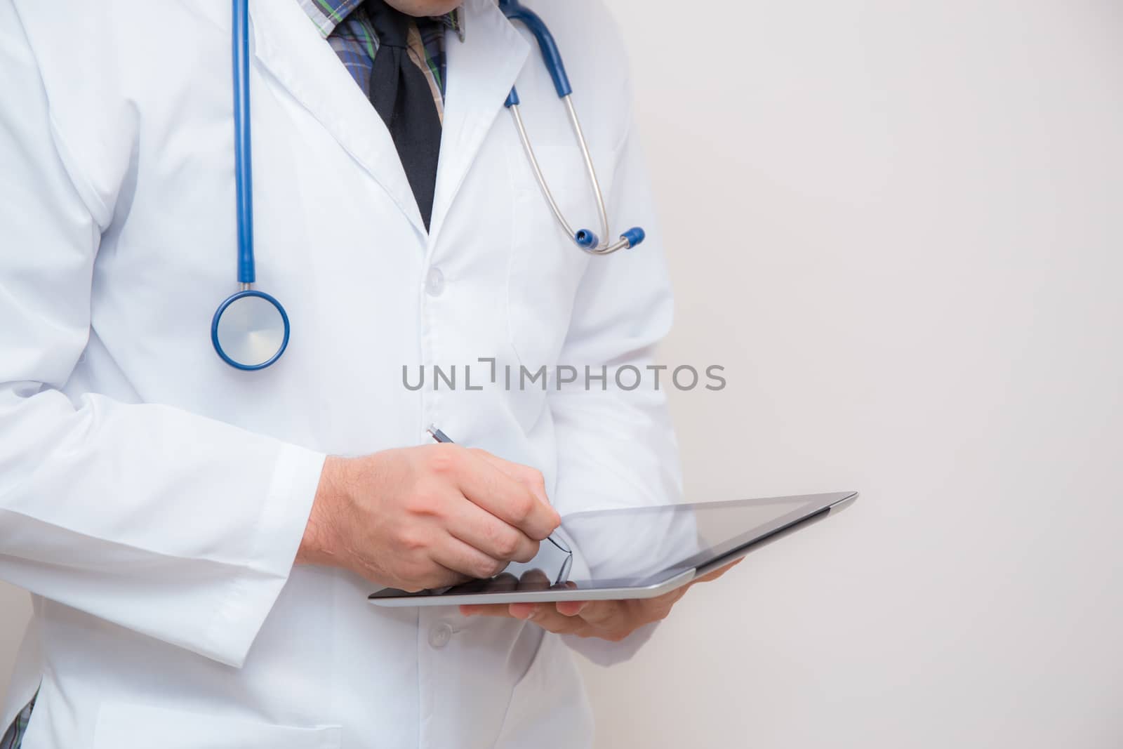 Doctor working on a digital tablet on white background.