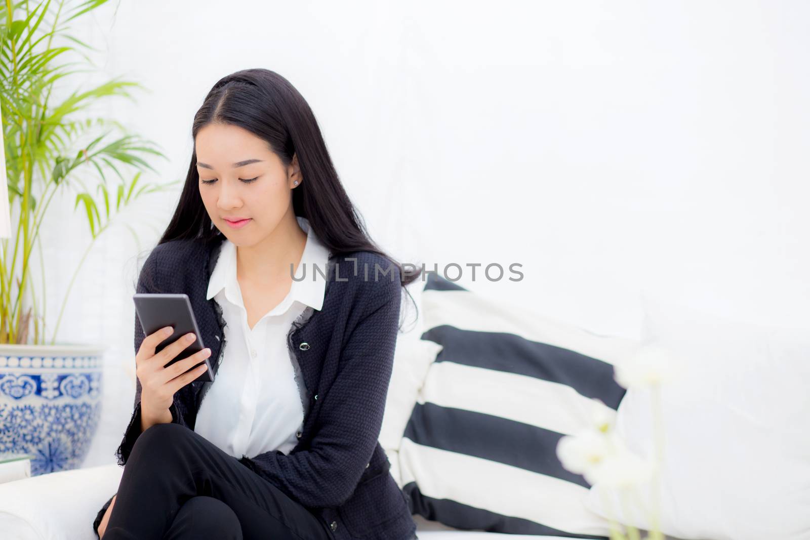 Young businesswoman asian sitting at table looking phone, business concept.
