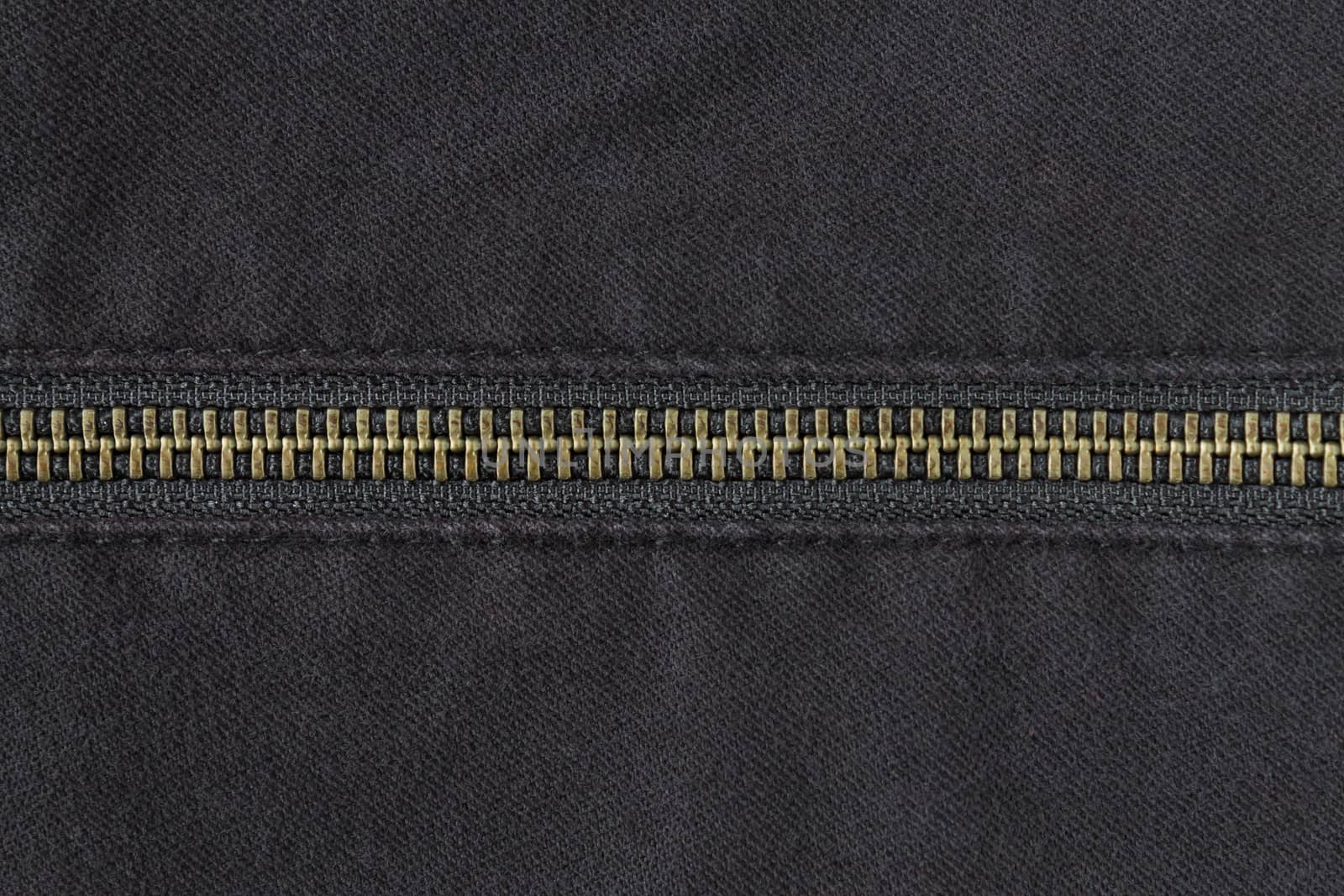 Brass Zip on Black Jeans Texture Background. Closed Brass Zip on Black Jeans Texture Background for Apparel Design
