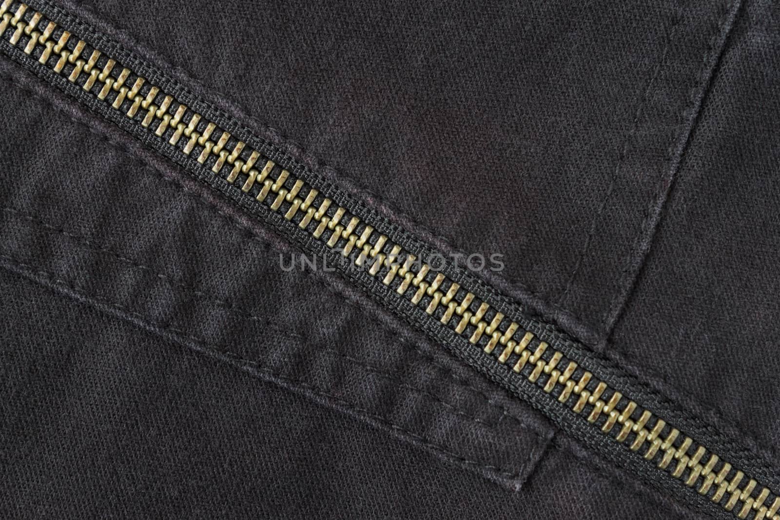 Brass Zip on Black Jeans Texture Background. Closed Brass Zip on Black Jeans Texture Background for Apparel Design