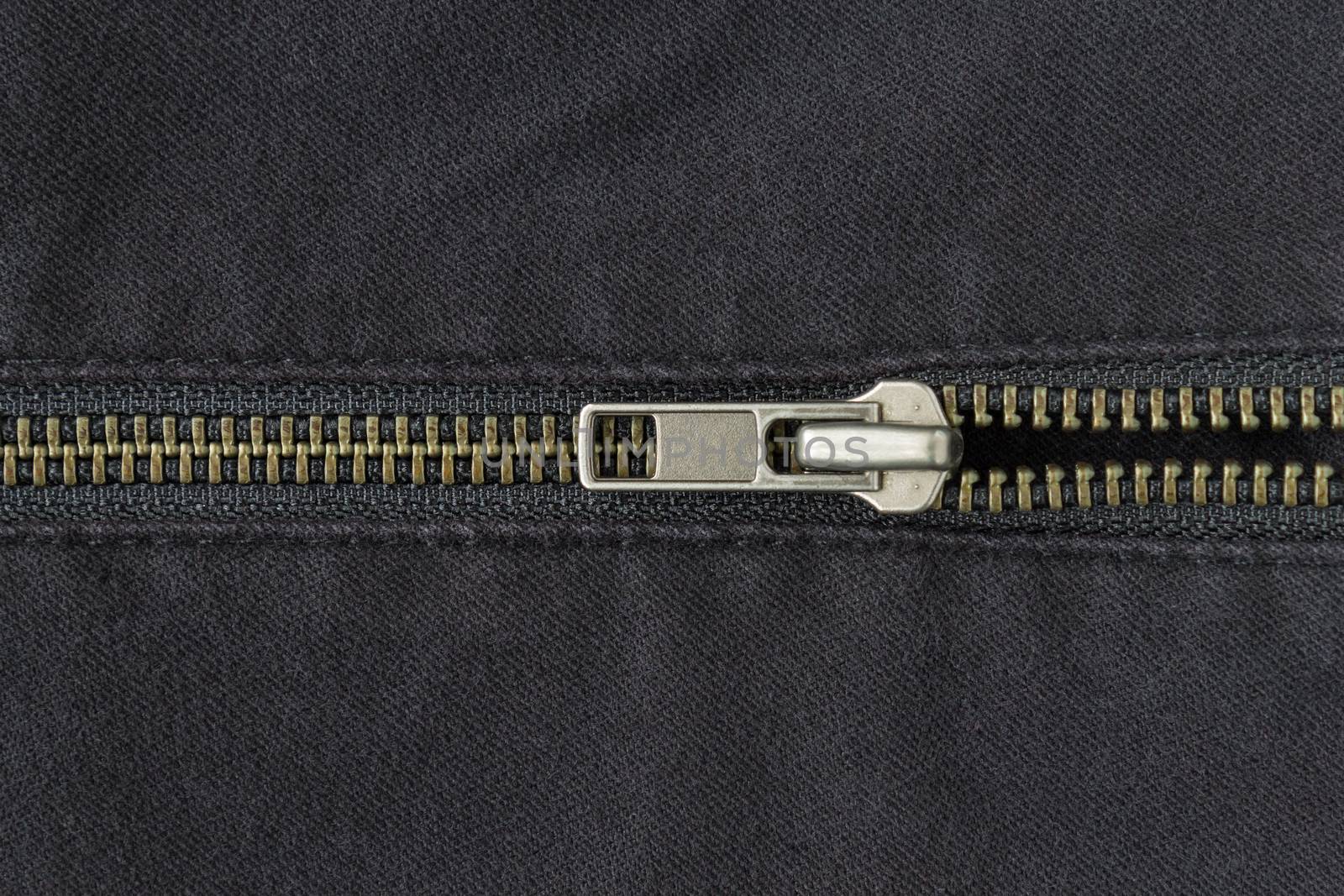 Open Half Brass Zip on Black Jeans Texture Background. Open Brass Zip on Black Jeans Texture Background for Apparel Design