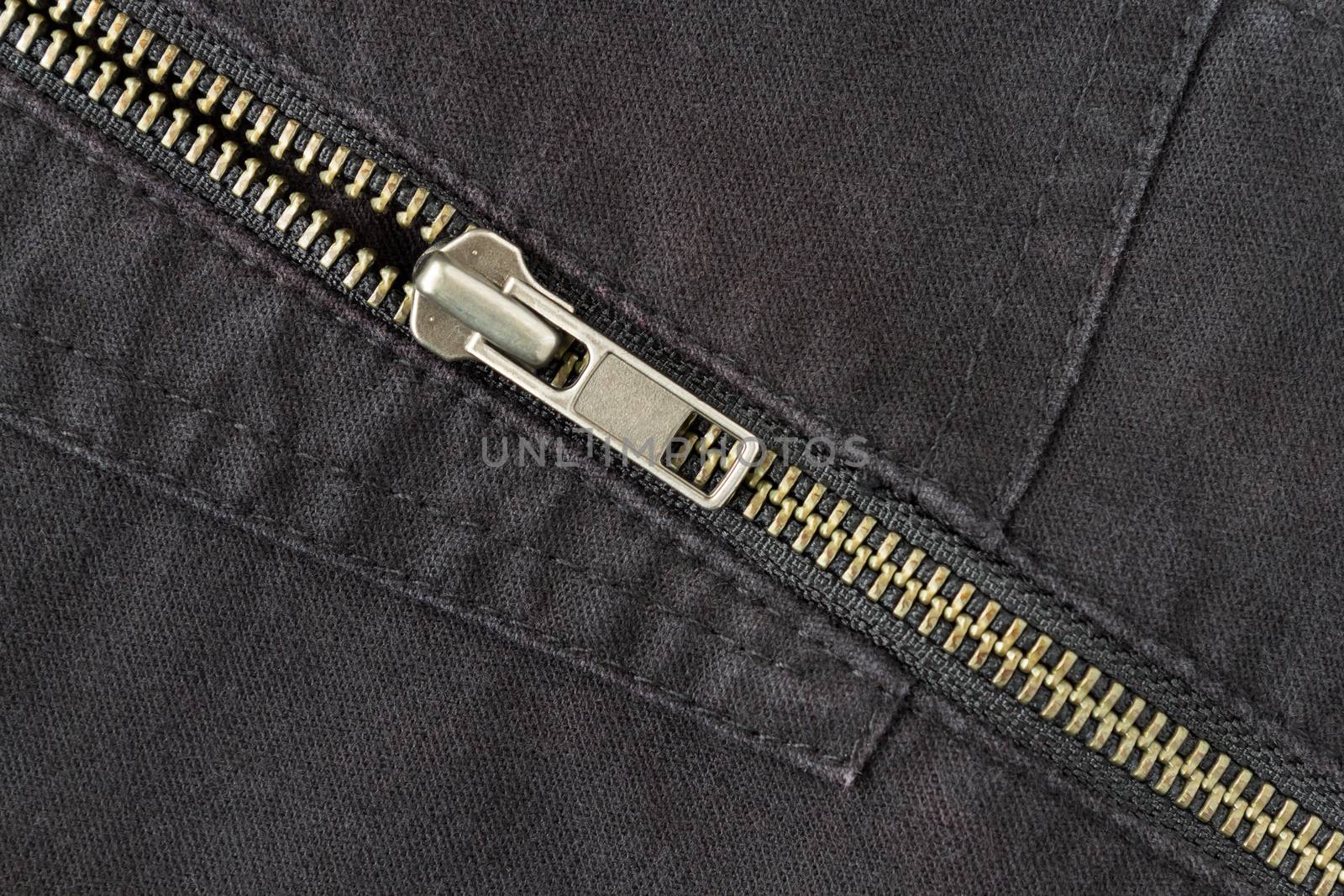 Open Crosswise Brass Zip on Black Jeans Texture Background. Open Brass Zip on Black Jeans Texture Background for Apparel Design