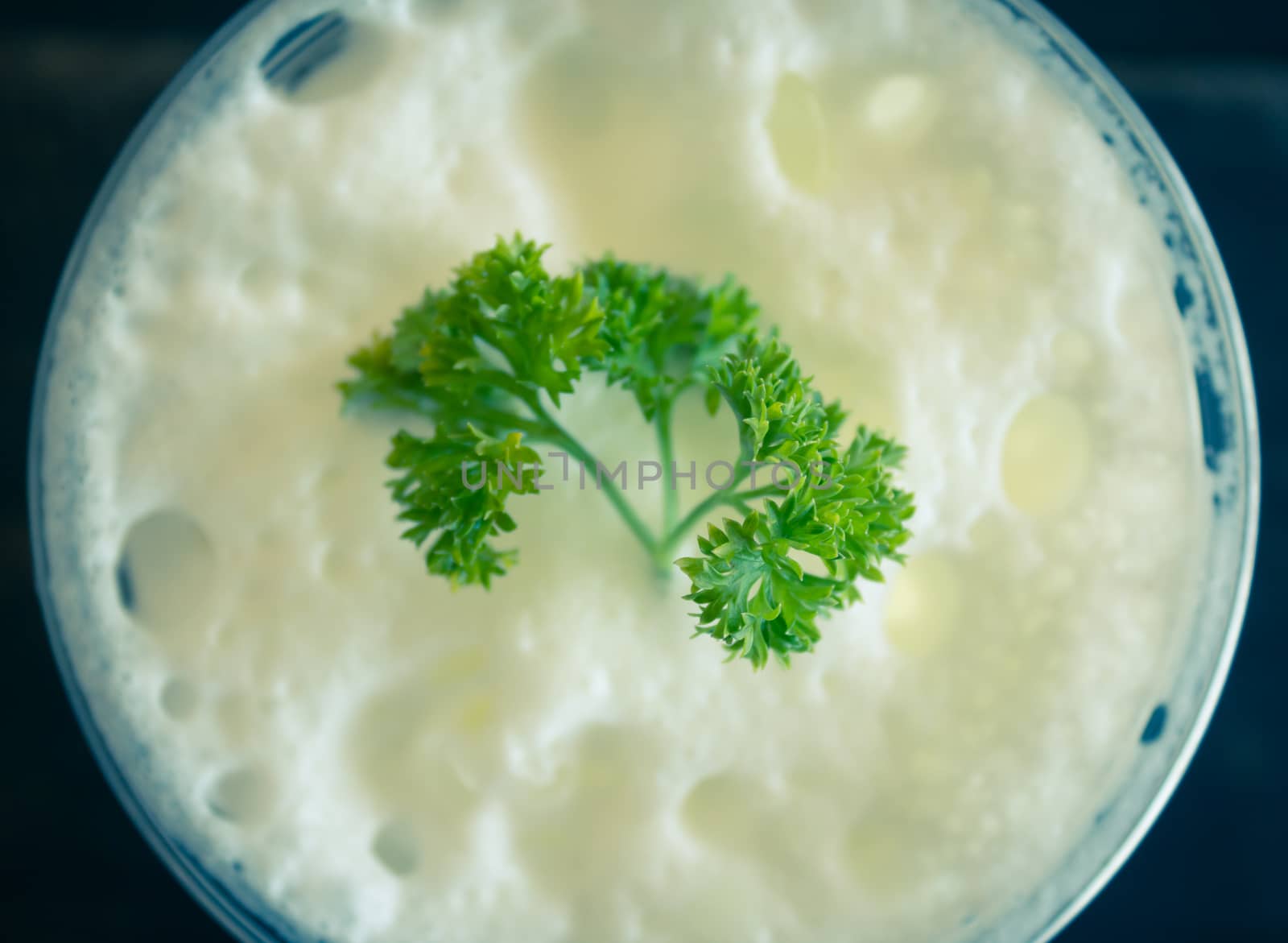 Milk froth and Parsley on Black Wood Table. Milk froth in plastic glass on wood table. Milk froth for food and drink category