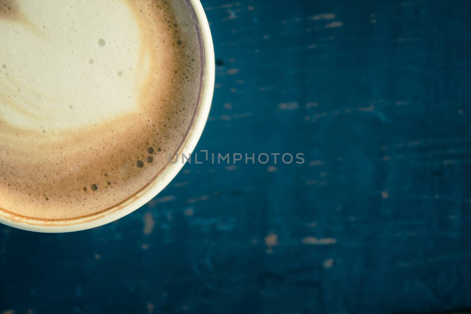 Vintage Flatlay Corner Heart Shape Froth Milk Latte Art in White Coffee Cup on Black Wood Table. Heart shape froth milk Latte art hot beverage for coffee lover