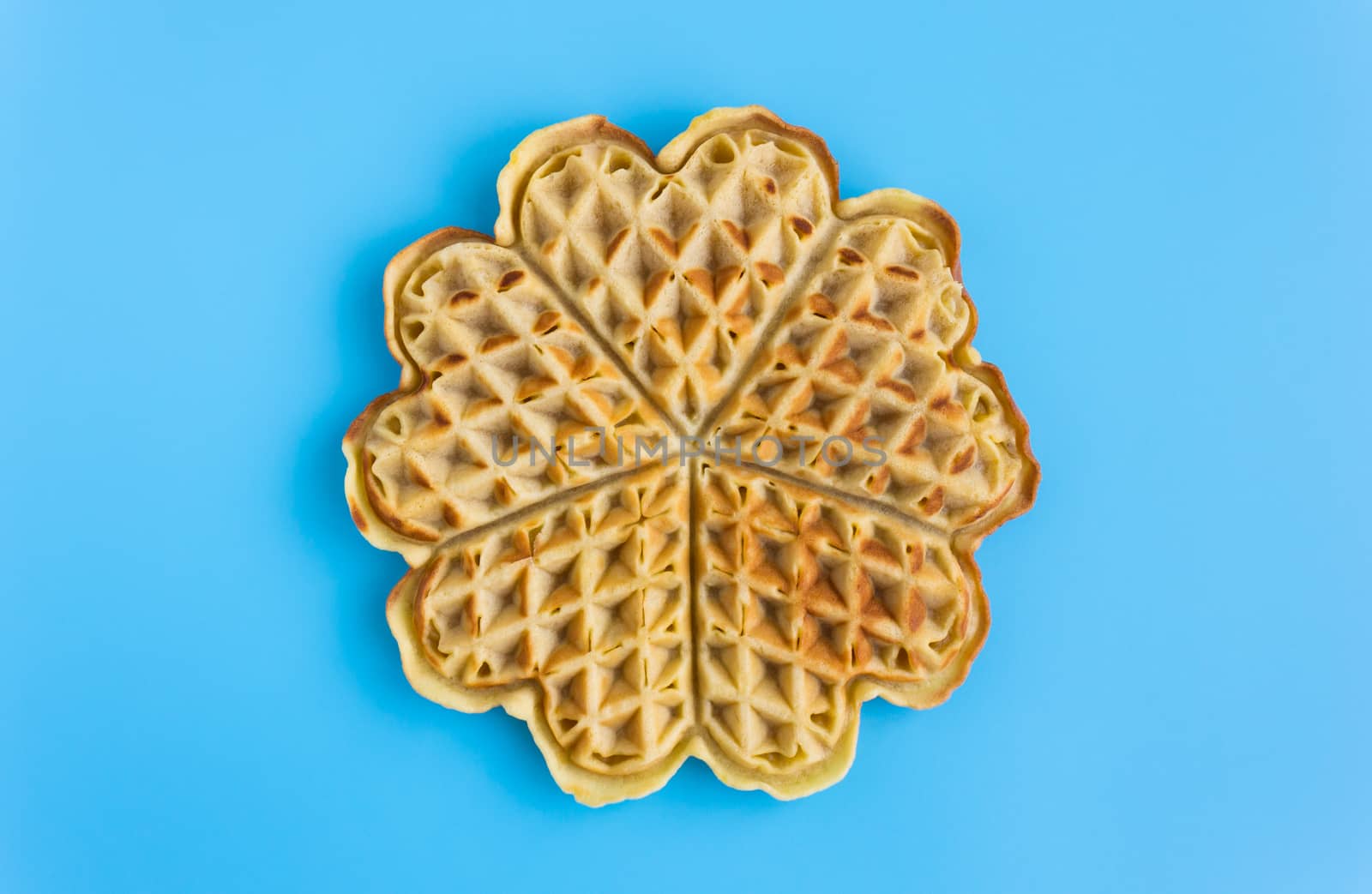 Full Piece Waffle on Blue Pastel Background Minimalist Style. No food color waffle on pastel background in dessert or food category