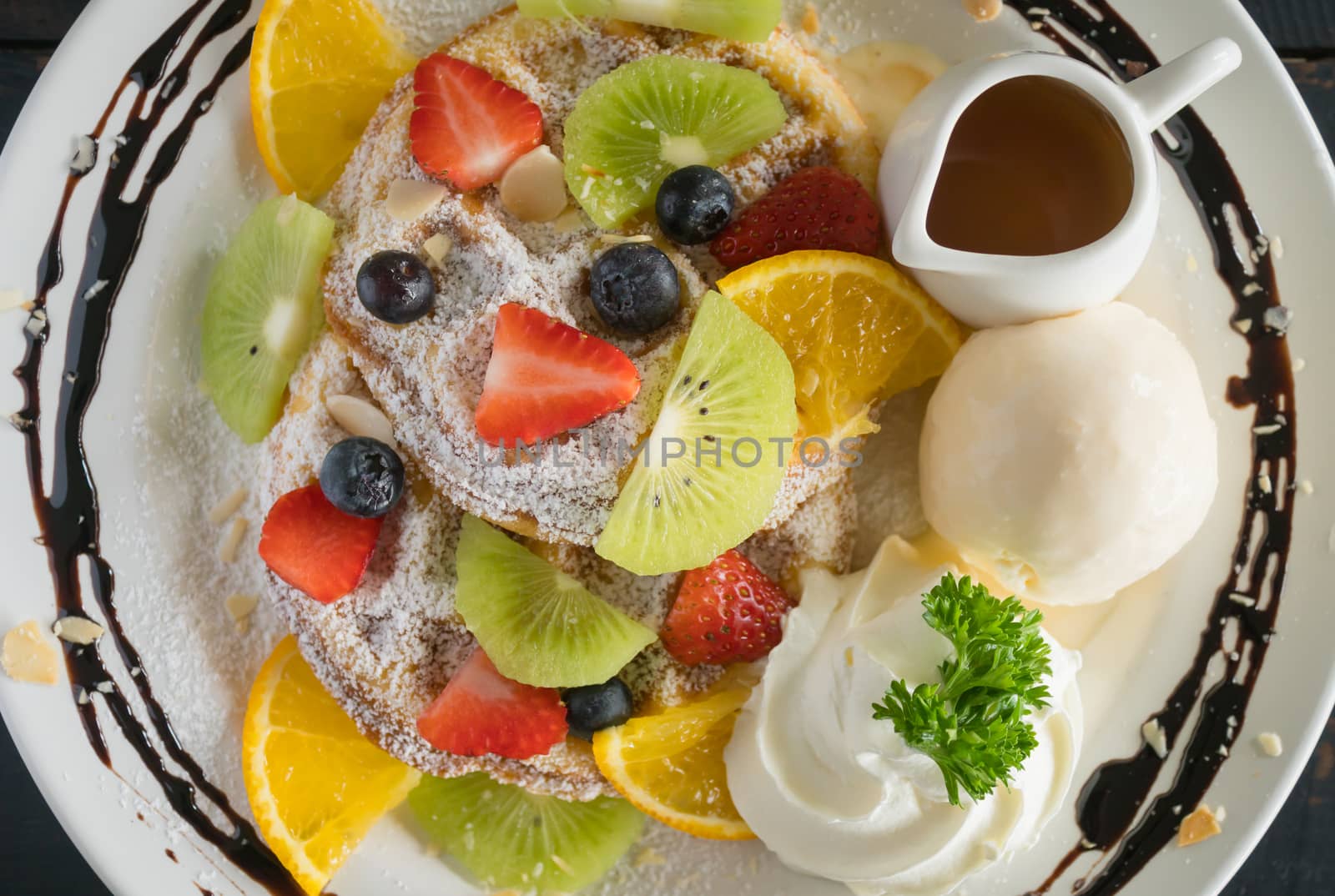 Flatlay Strawberry Blueberry Kiwi Lemon Waffle Whipped Cream Ice Cream Chocolate and Syrup Dessert. Fruity dessert food and drink category