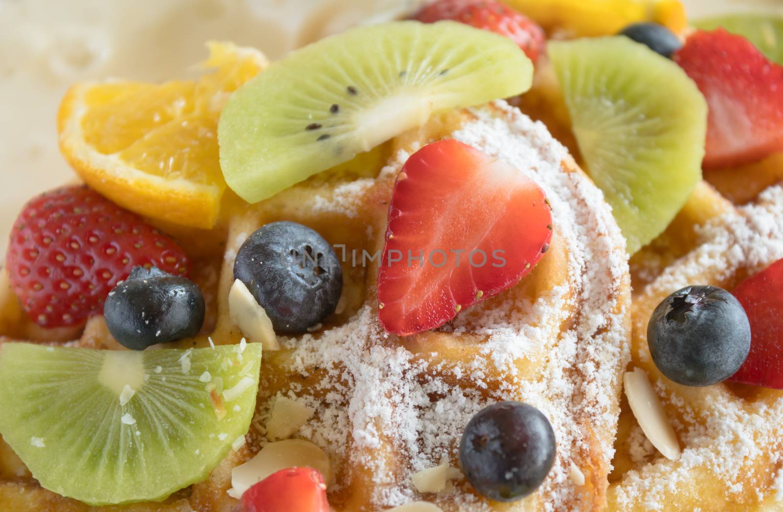 Strawberry Blueberry Kiwi Lemon Waffle Dessert Close Up. Fruity dessert food and drink category