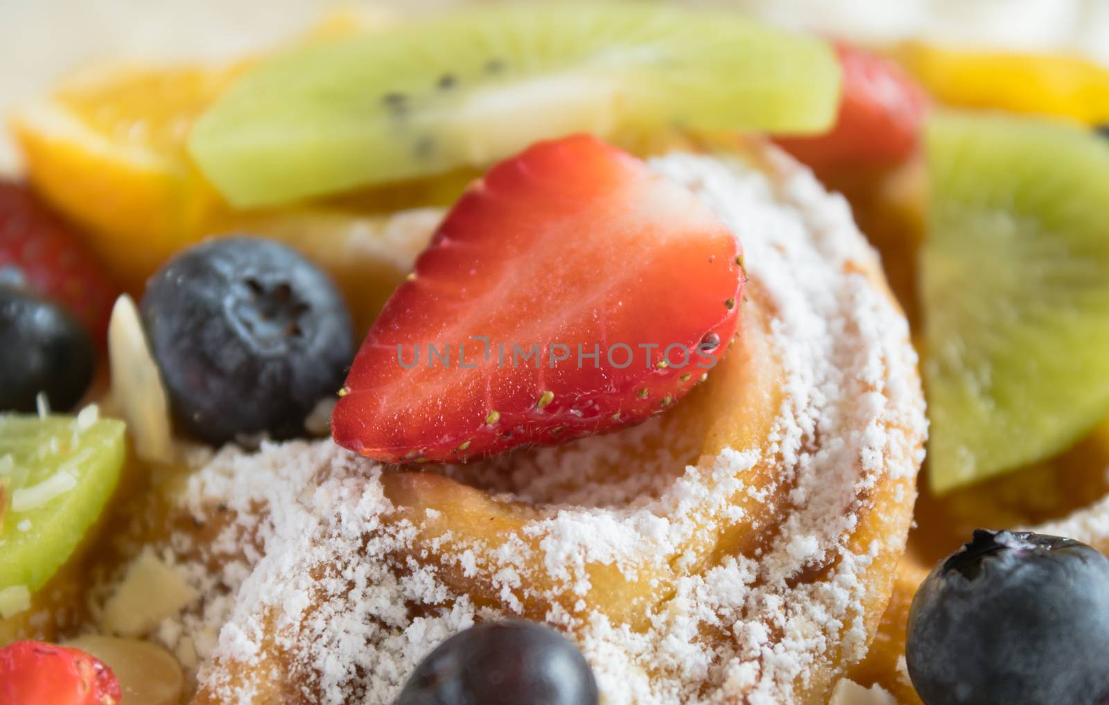 Strawberry Blueberry Kiwi Lemon Waffle Dessert Close Up. Fruity dessert food and drink category