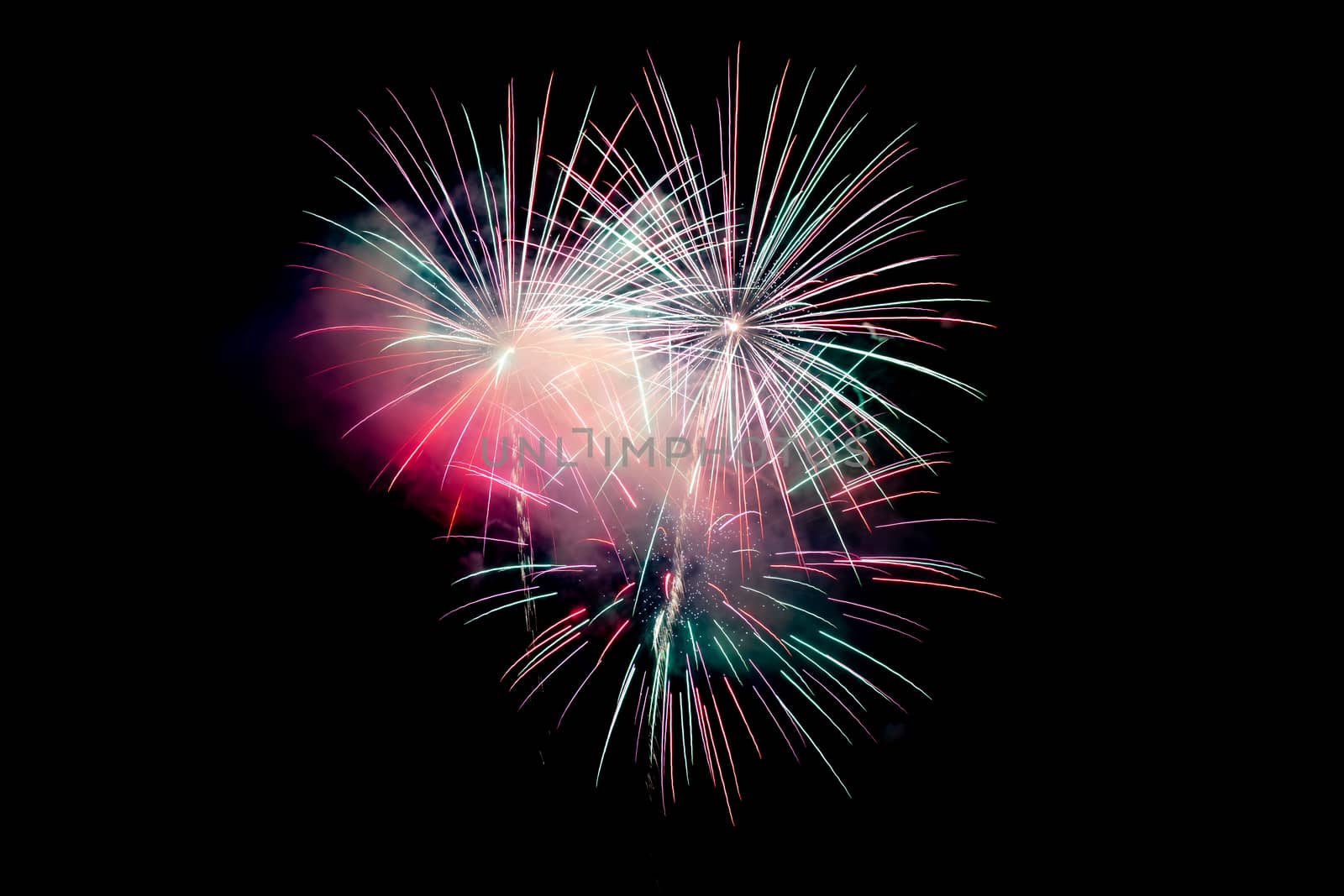 Red Green Sparkling Fireworks Background on Night Scene. Abstract color fireworks background and smoke on sky