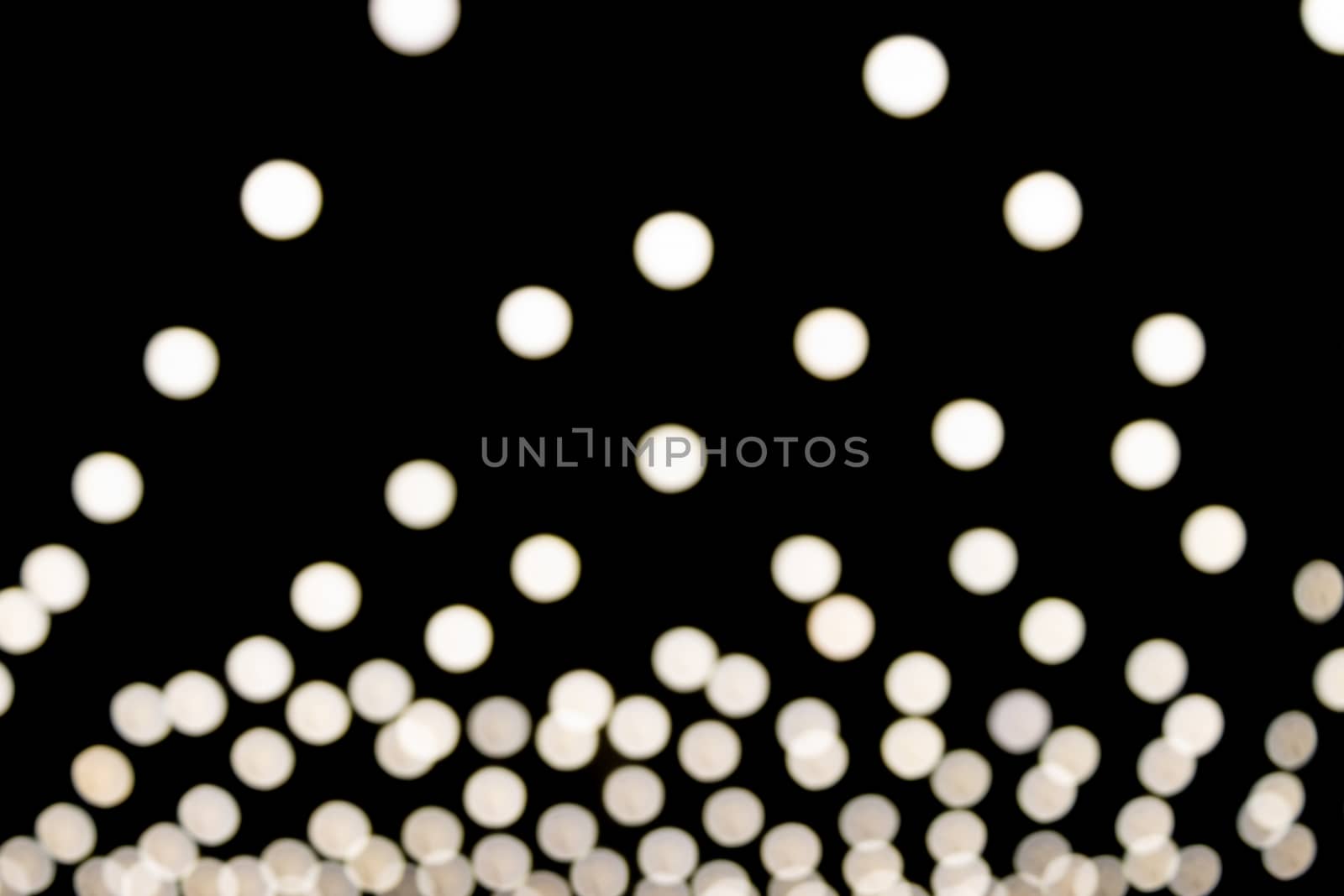 White Triangle Shape Blurred Lights on Black Background