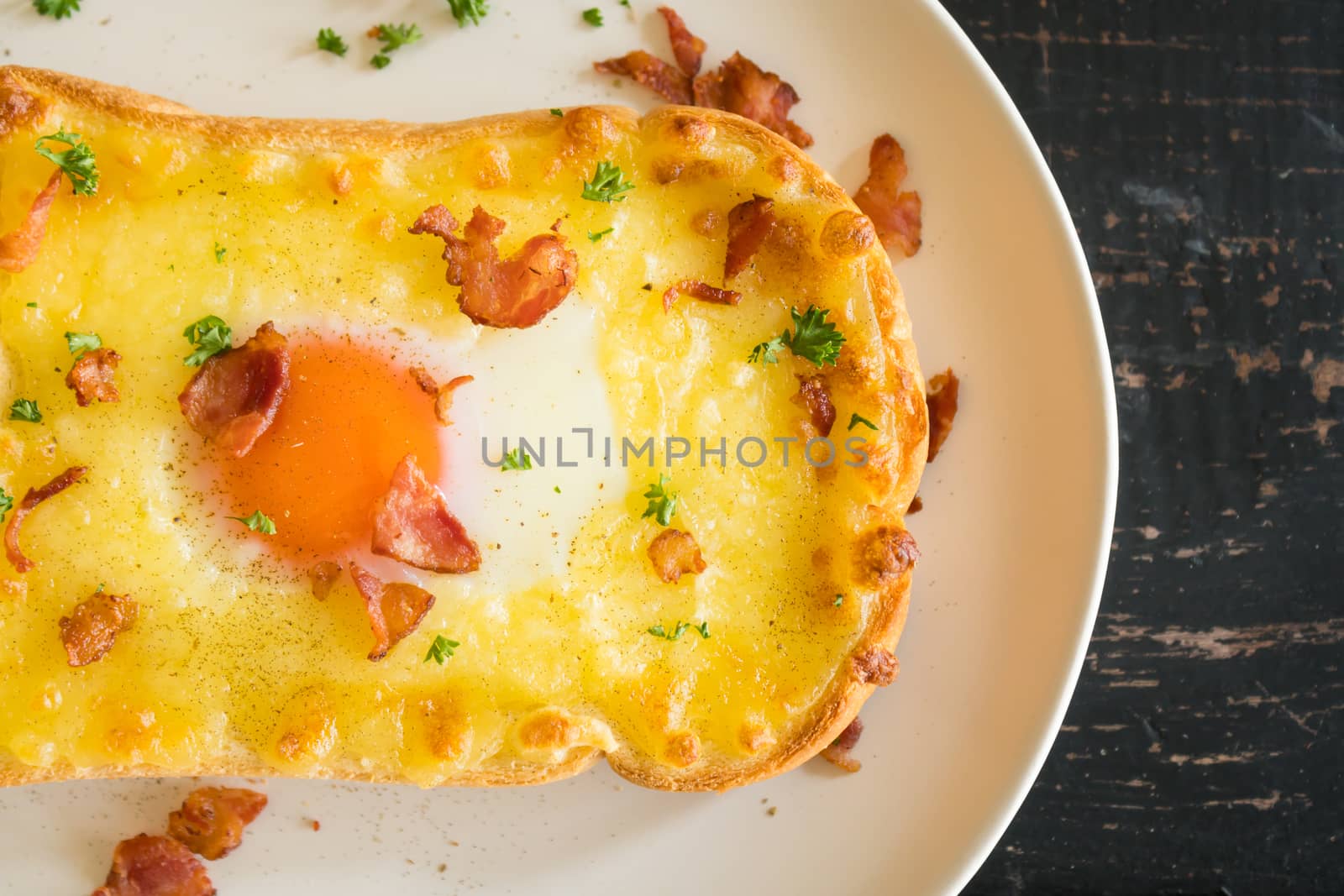 Egg Yolk Bacon Ham Cheese Toast and Coriander. Breakfast egg yolk bacon ham cheese with bread toast with coriander on top for food and drink category