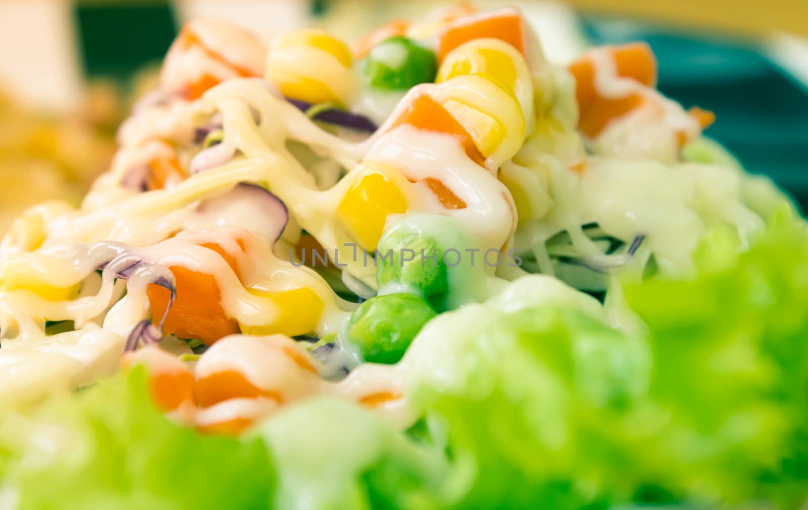 Vegan or Vegetarian Salad with Mayonnaise Topping in Close Up View include Carrot and Tomato and Corn and Cabbage and Peas and Lettuce in Vintage Tone