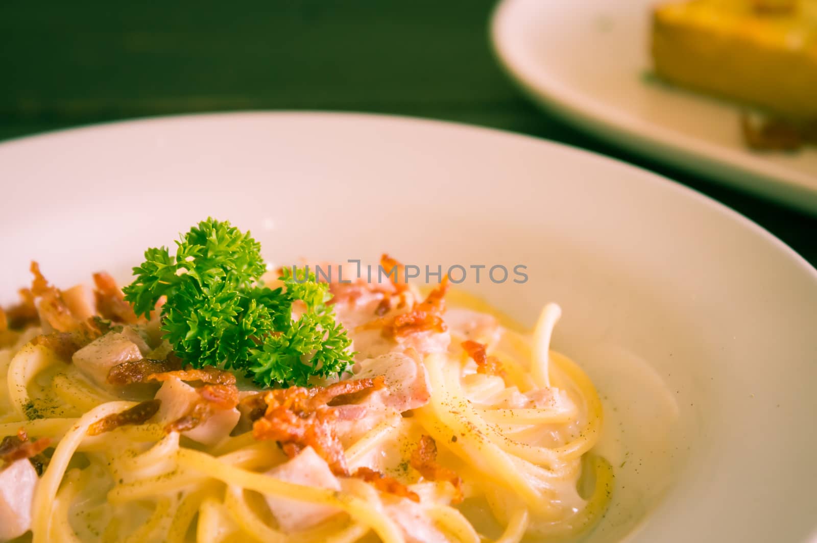 Spaghetti Carbonara with Bacon and Ham and Parsley and Mayonnaise Sauce. Spaghetti Carbonara with Bacon and Ham in mayonnaise cream sauce for food and drink category. 
Spaghetti Carbonara with Bacon breakfast