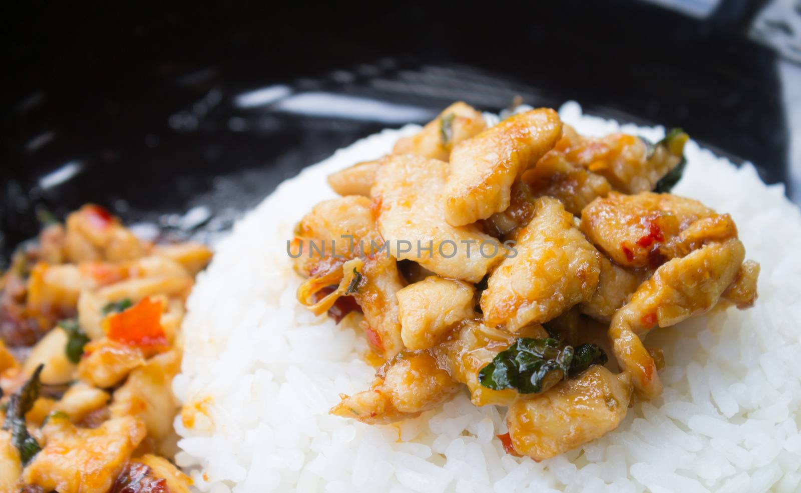 Stir-Fried Chicken and Holy Basil on Rice or Thai Food Recipe Right Frame. Stir-Fried Chicken and Holy Basil with white rice on black dish