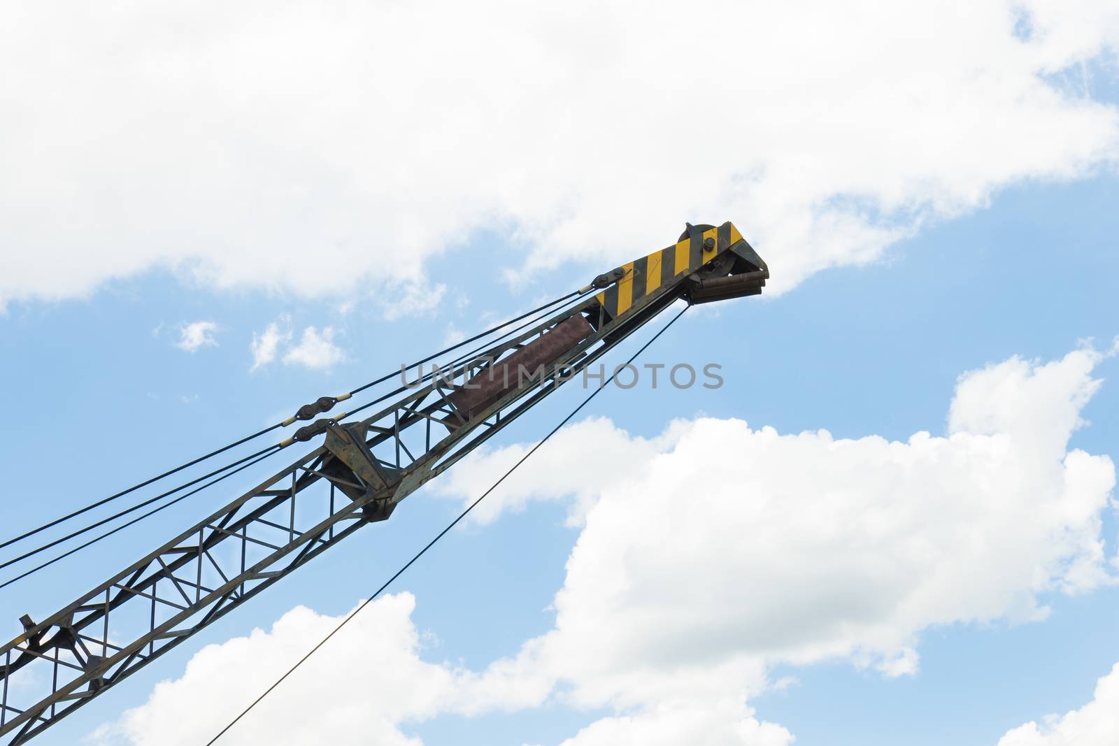 Crane head or iron structure and metal sling on blue sky background on side view. Lifting machine heavy object in construction industry