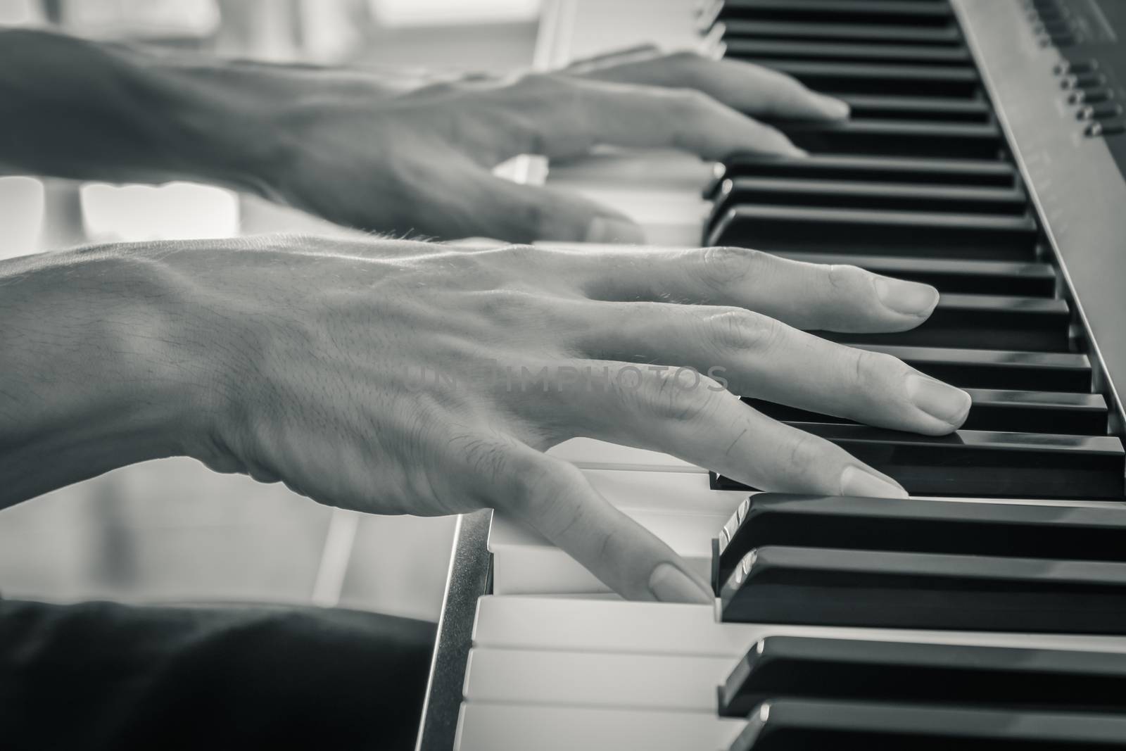 Hand of Piano Player on White Keys and Black Keys of Electric Piano in Zoom View