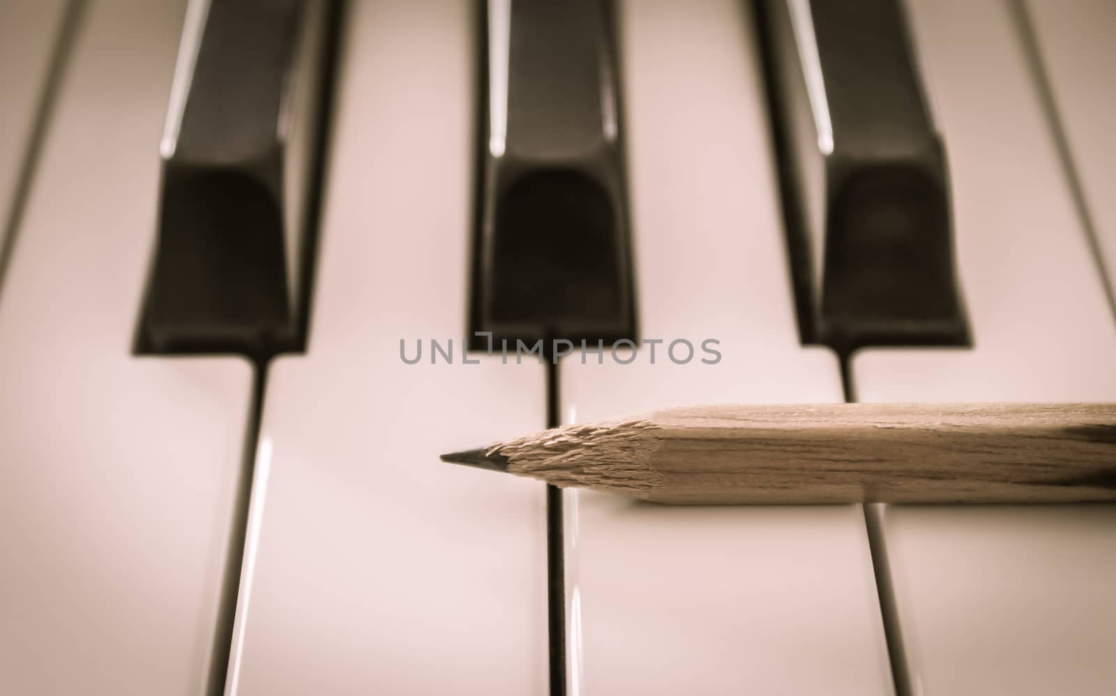 Old Pencil on White Keys of Electric Piano in Horizontal View. Concept about Piano Playing or Piano Learning